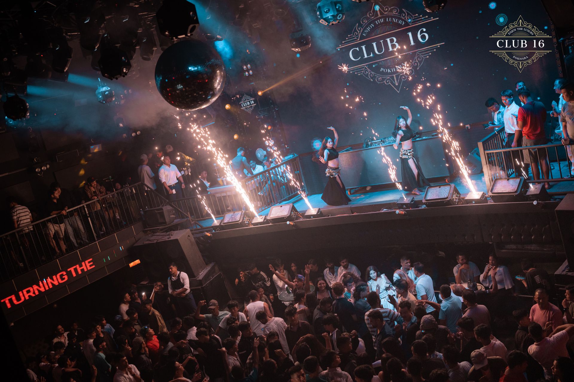 Crowd dancing under the lights